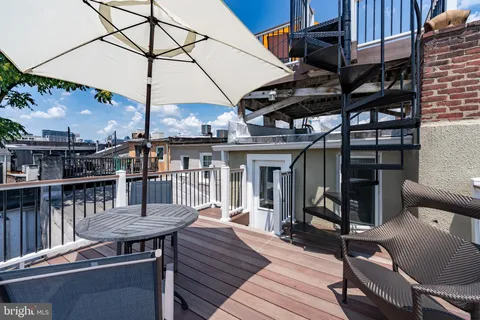 a aerial view of a house with a yard and potted plants