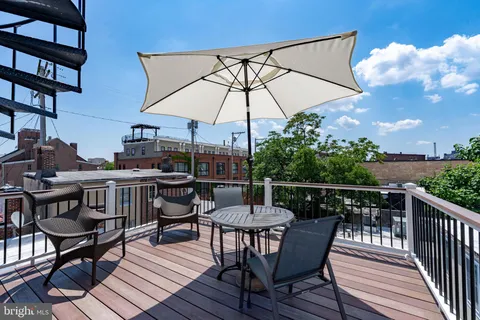a kitchen with a refrigerator a sink and chairs