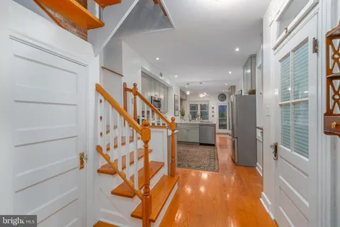 a view of entryway and hall with wooden floor
