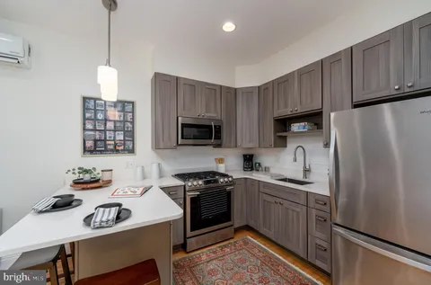 a view of a terrace with furniture and a garden