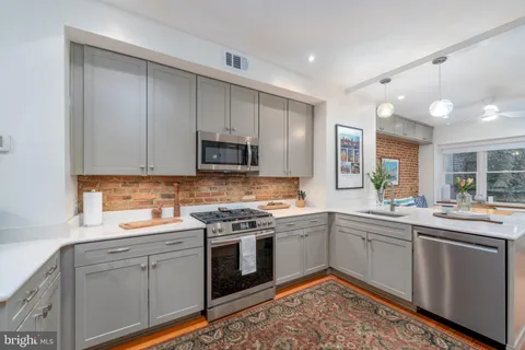 a kitchen with a sink stove and cabinets