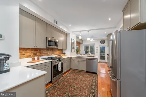 a kitchen with a sink stainless steel appliances and cabinets