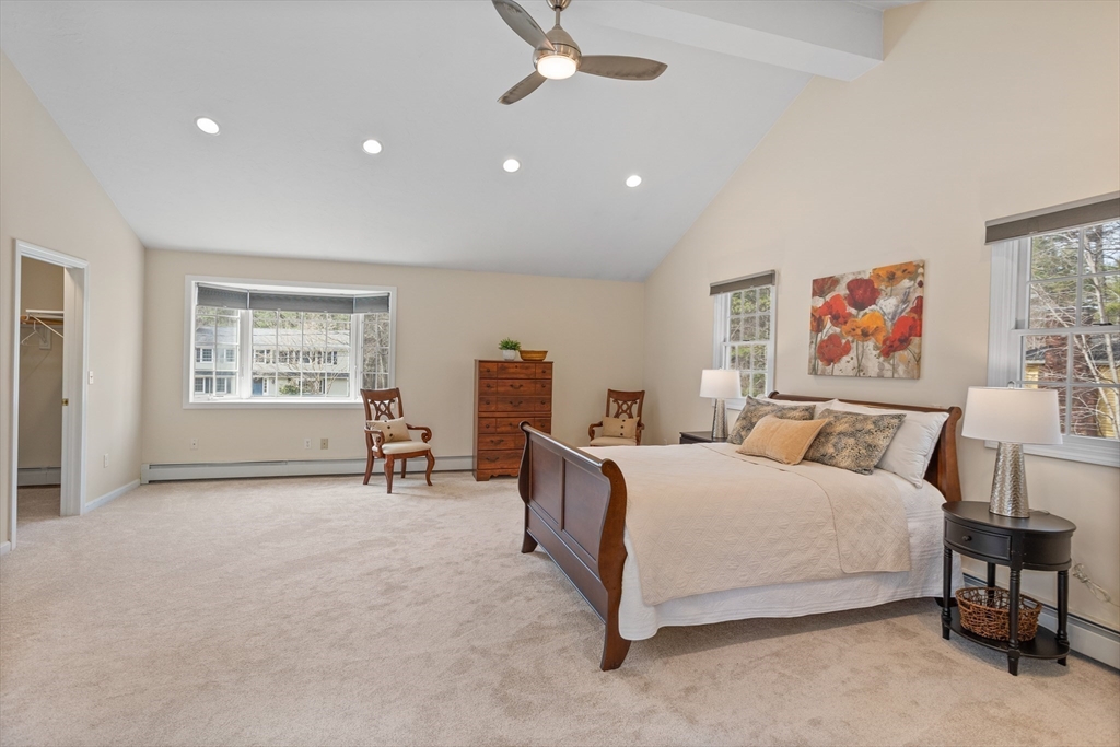 10 Lincoln Drive Acton, MA 01720 - Photo 11 of 32 a spacious bedroom with a bed a table and a large window