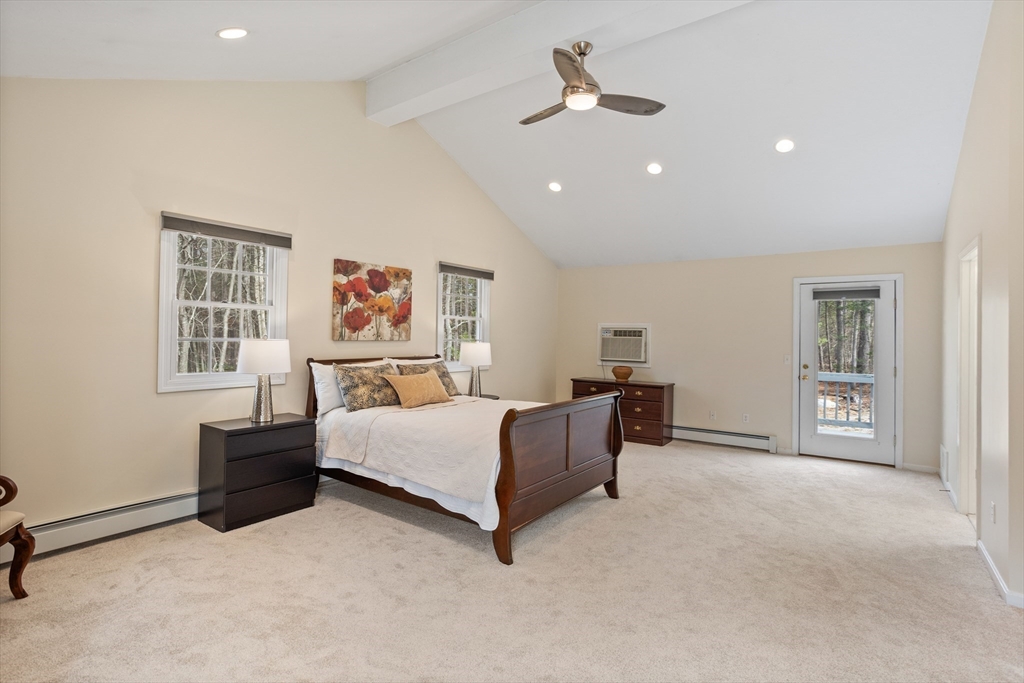 10 Lincoln Drive Acton, MA 01720 - Photo 12 of 32 a spacious bedroom with a bed and a chandelier