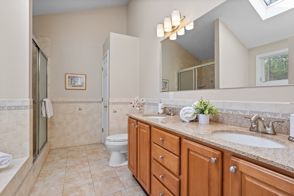 10 Lincoln Drive Acton, MA 01720 - Photo 14 of 32 a spacious bathroom with a granite countertop sink a toilet and a mirror