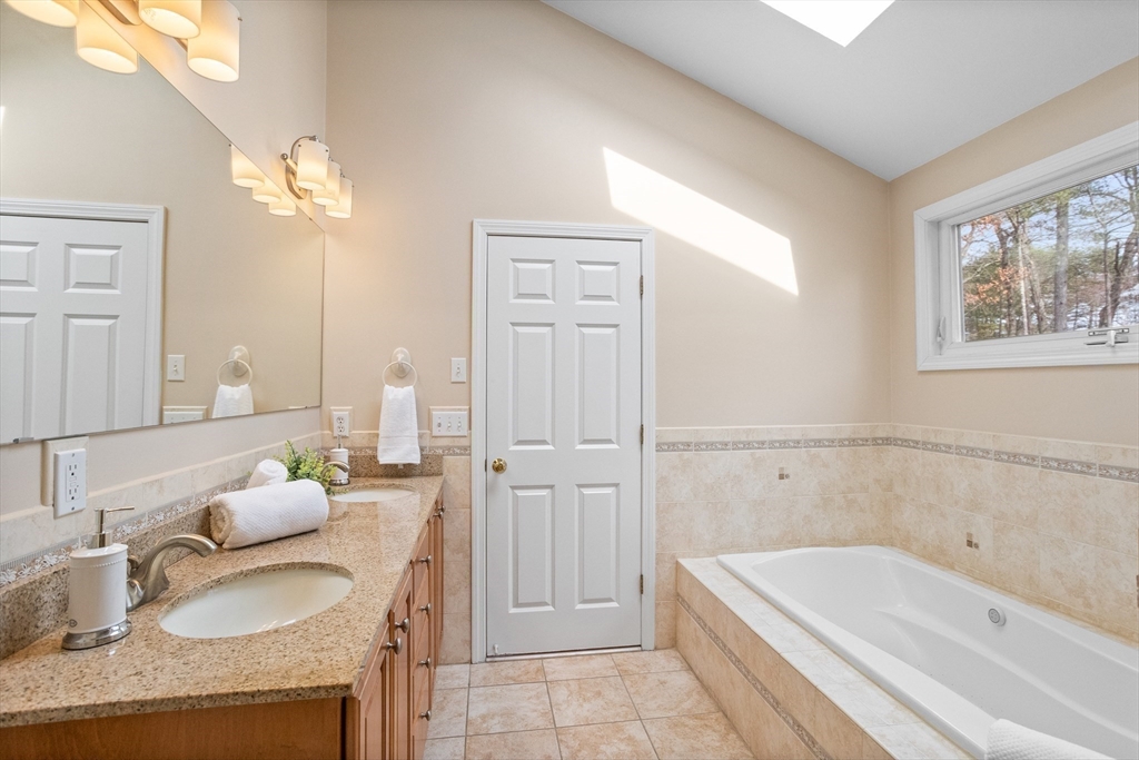 10 Lincoln Drive Acton, MA 01720 - Photo 15 of 32 a bathroom with a granite countertop sink and a bathtub