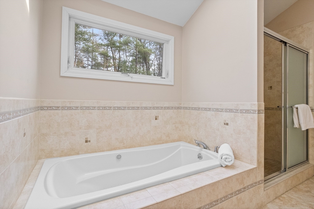 10 Lincoln Drive Acton, MA 01720 - Photo 16 of 32 a bathroom with a tub a window and a shower