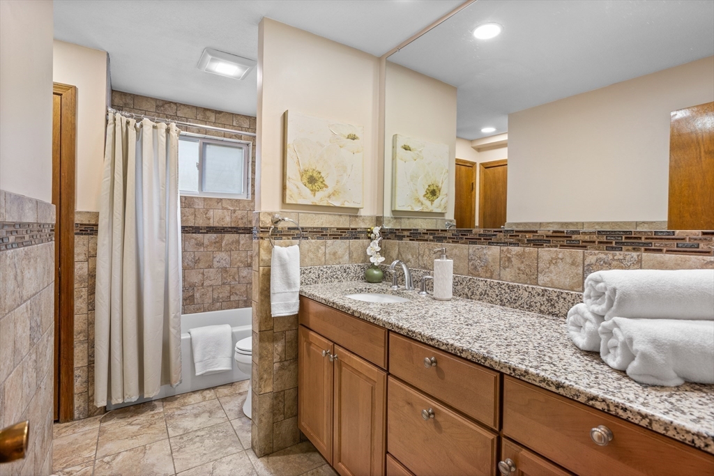 10 Lincoln Drive Acton, MA 01720 - Photo 19 of 32 a bathroom with a granite countertop sink and a mirror