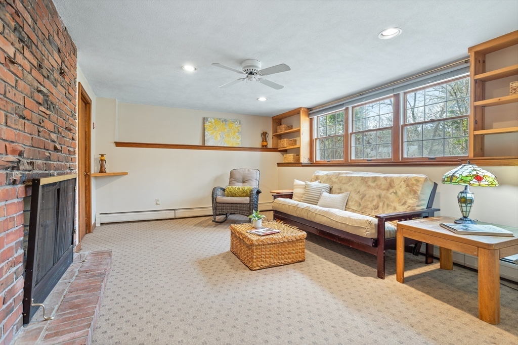 10 Lincoln Drive Acton, MA 01720 - Photo 25 of 32 a living room with furniture and a fireplace