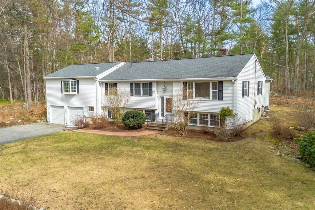 10 Lincoln Drive Acton, MA 01720 - Photo 32 of 32 front view of a house with a patio