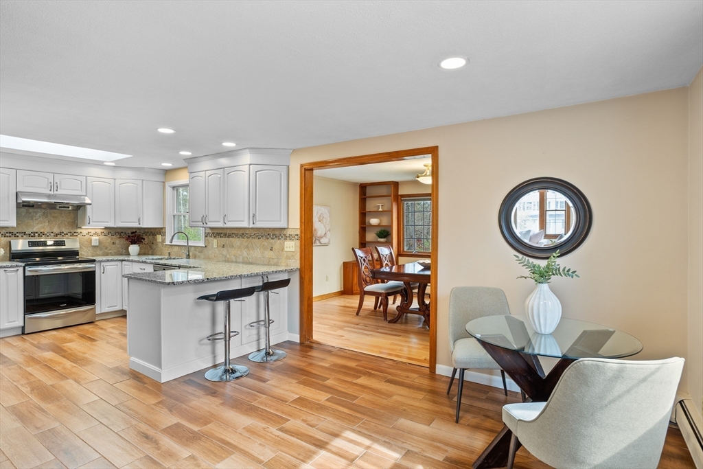 10 Lincoln Drive Acton, MA 01720 - Photo 4 of 32 a kitchen with a dining table chairs and white cabinets