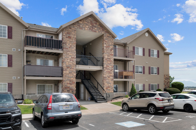 25 West Ridge Road, Unit 25 Saratoga Springs, UT 84045 - Photo 20 of 22 Multi-story residential building featuring a stone facade and beige siding