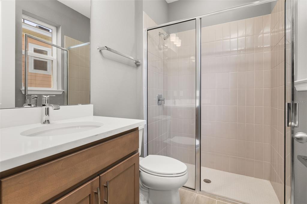 985 Fiesta Key Circle Lady Lake, FL 32159 - Photo 21 of 34 a bathroom with a sink toilet and shower