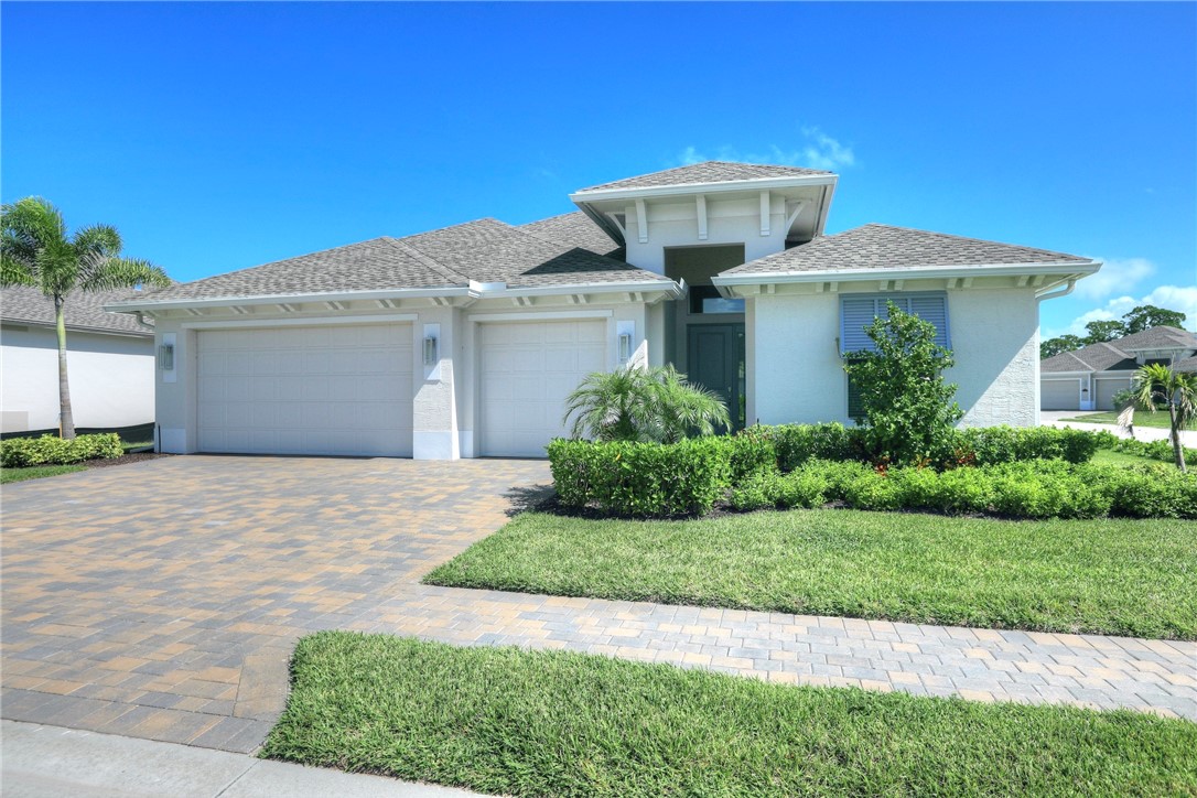 6423 High Pointe Circle Vero Beach, FL 32967 - Photo 1 of 36 a front view of a house with a garden