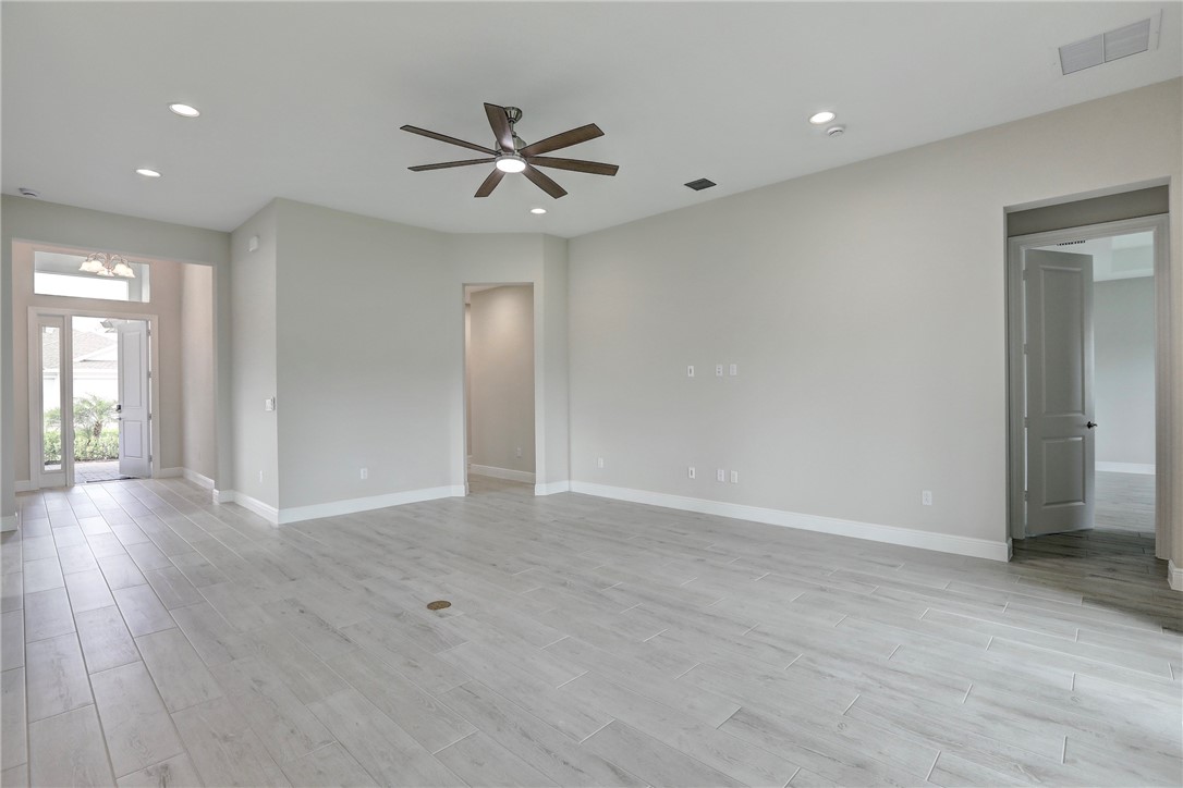 6423 High Pointe Circle Vero Beach, FL 32967 - Photo 11 of 36 a view of an empty room with wooden floor and a window