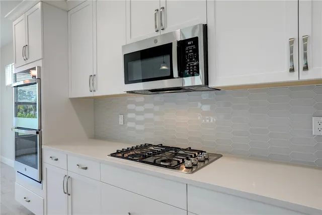 a stove top oven sitting inside of a kitchen