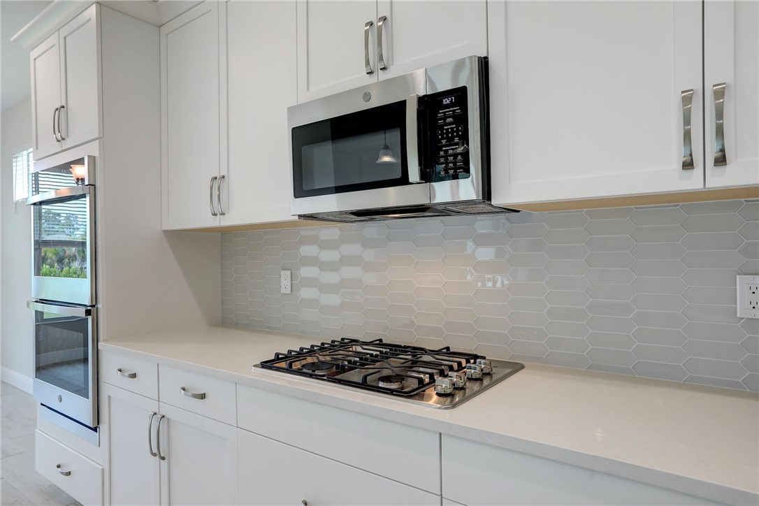 6423 High Pointe Circle Vero Beach, FL 32967 - Photo 19 of 36 a stove top oven sitting inside of a kitchen