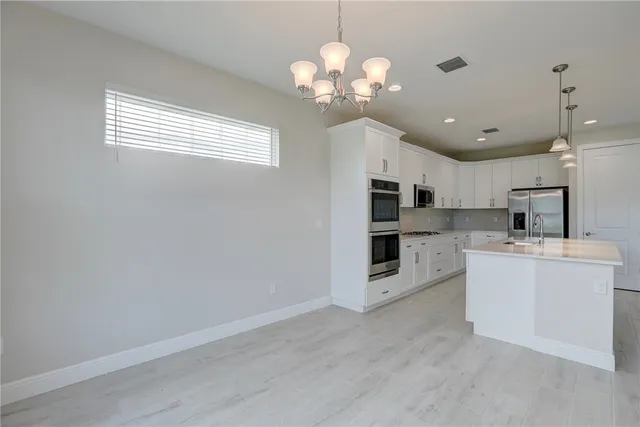 a view of a kitchen with a sink and cabinet area