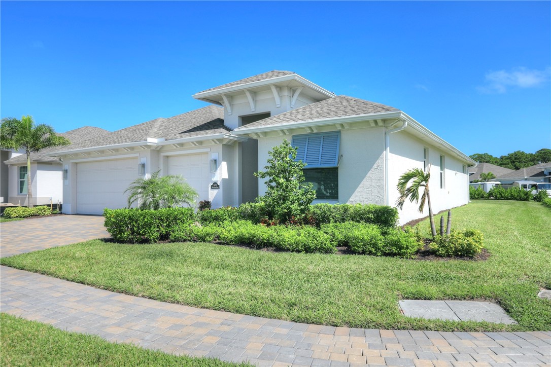 6423 High Pointe Circle Vero Beach, FL 32967 - Photo 2 of 36 a front view of a house with a yard