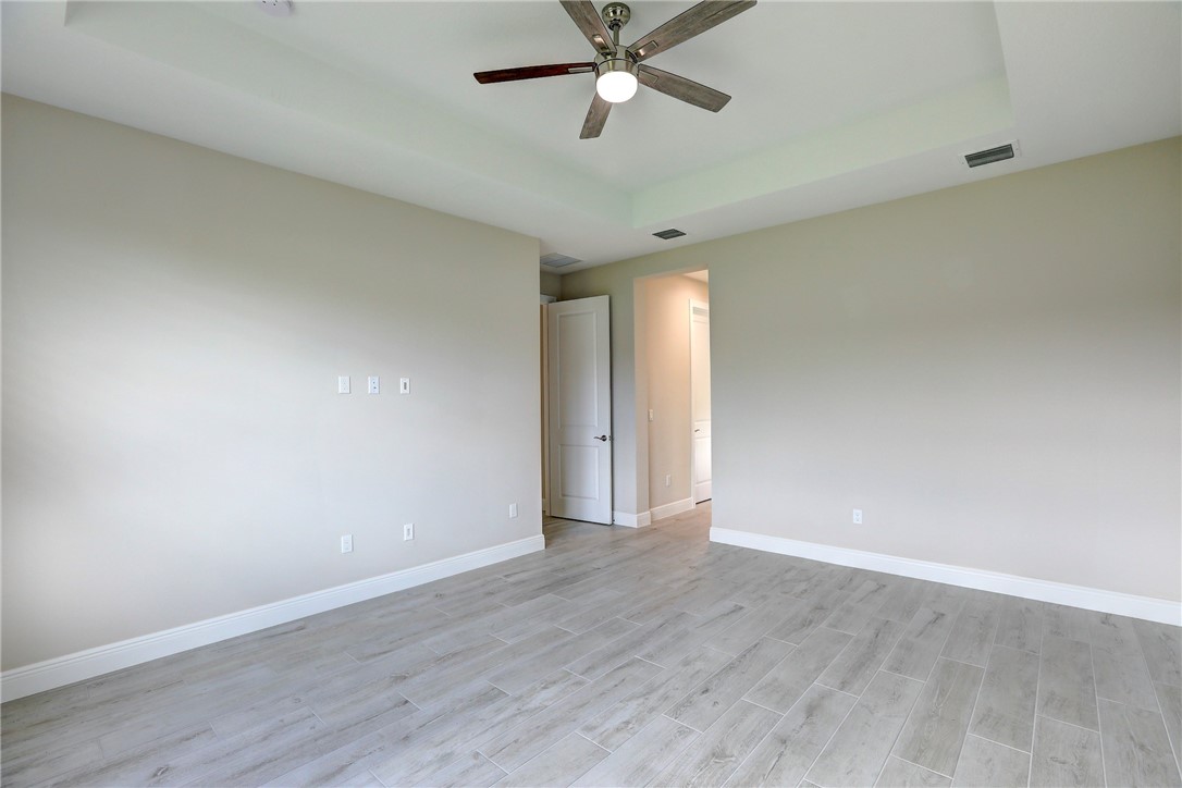 6423 High Pointe Circle Vero Beach, FL 32967 - Photo 24 of 36 a view of an empty room with window a ceiling fan and wooden floor