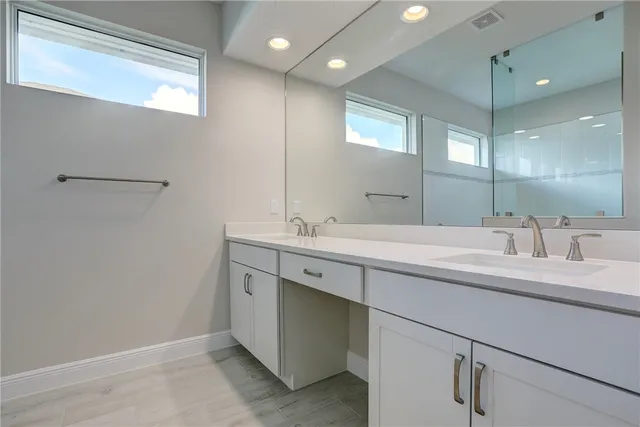 a bathroom with a double vanity sink and a mirror