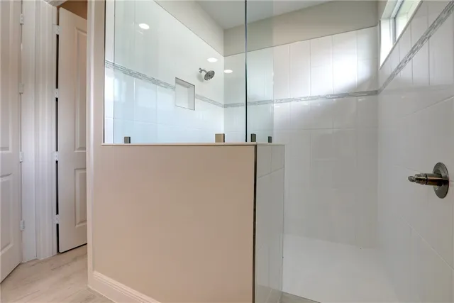 a bathroom with a shower and a glass door