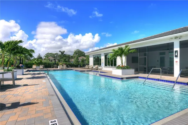 a view of a house with swimming pool and sitting area