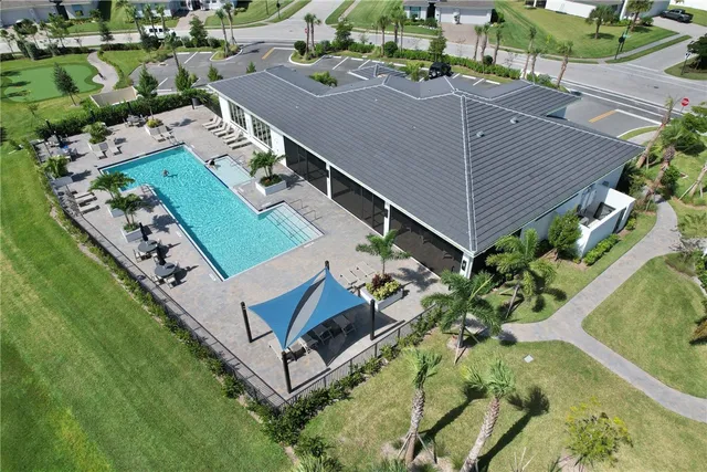 an aerial view of a house with a yard