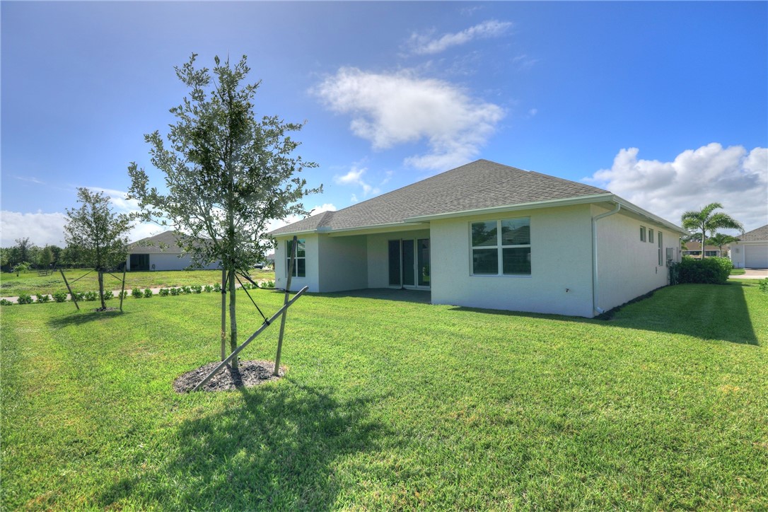 6423 High Pointe Circle Vero Beach, FL 32967 - Photo 4 of 36 a view of a house with a yard and a garden