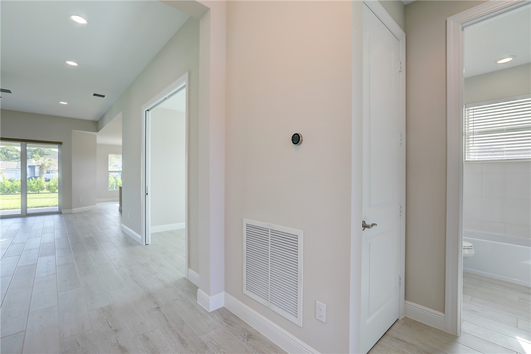6423 High Pointe Circle Vero Beach, FL 32967 - Photo 7 of 36 a view of a hallway with wooden floor and windows