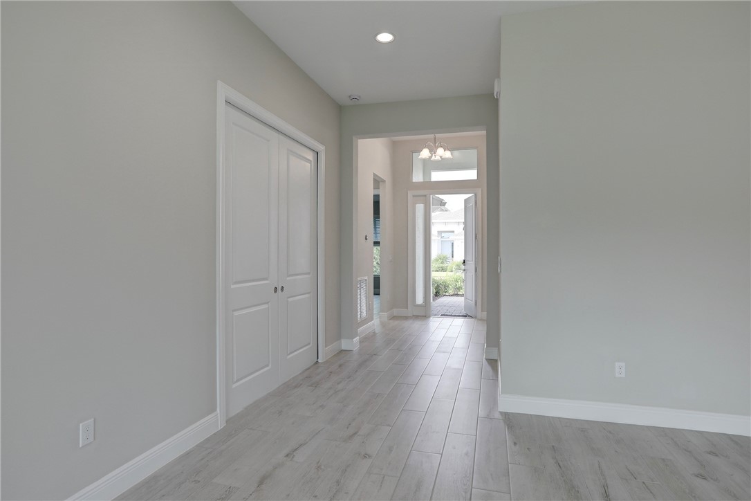 6423 High Pointe Circle Vero Beach, FL 32967 - Photo 8 of 36 a view of a hallway with wooden floor