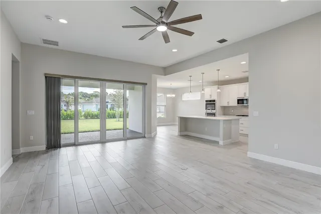 a view of a kitchen with a sink and wooden floor