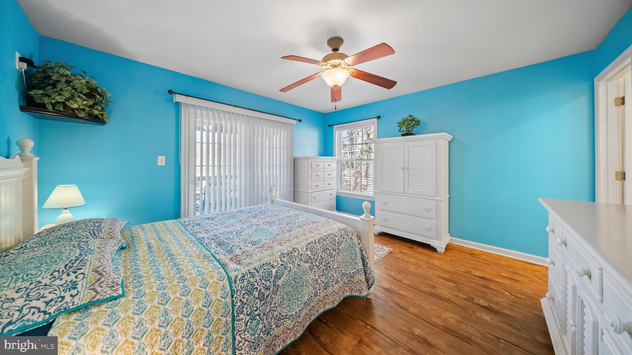 128 Sandyhook Road Ocean Pines, MD 21811 - Photo 14 of 37 a bedroom with a bed and a chandelier