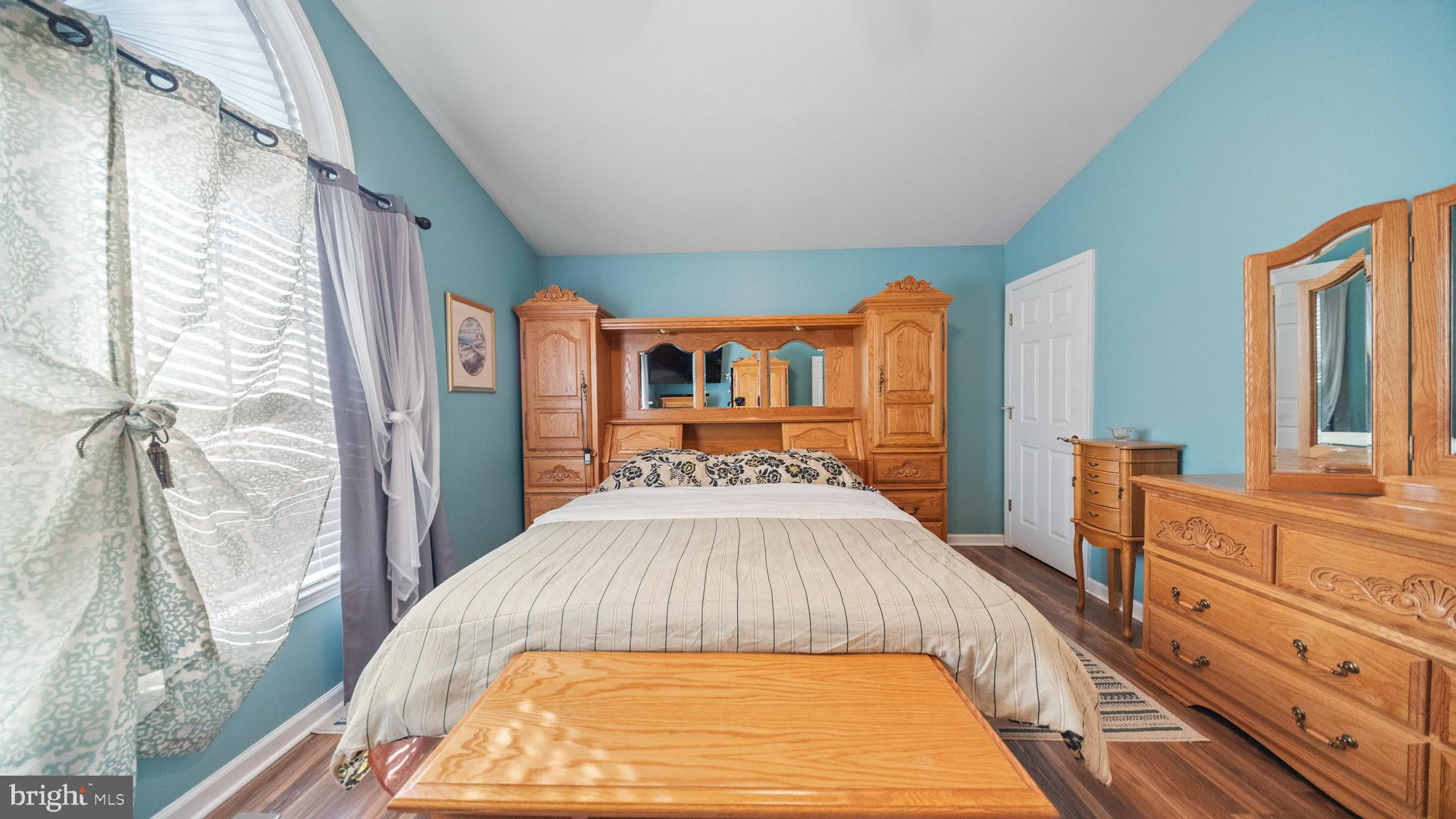 128 Sandyhook Road Ocean Pines, MD 21811 - Photo 22 of 37 a bed sitting in a bedroom next to a window