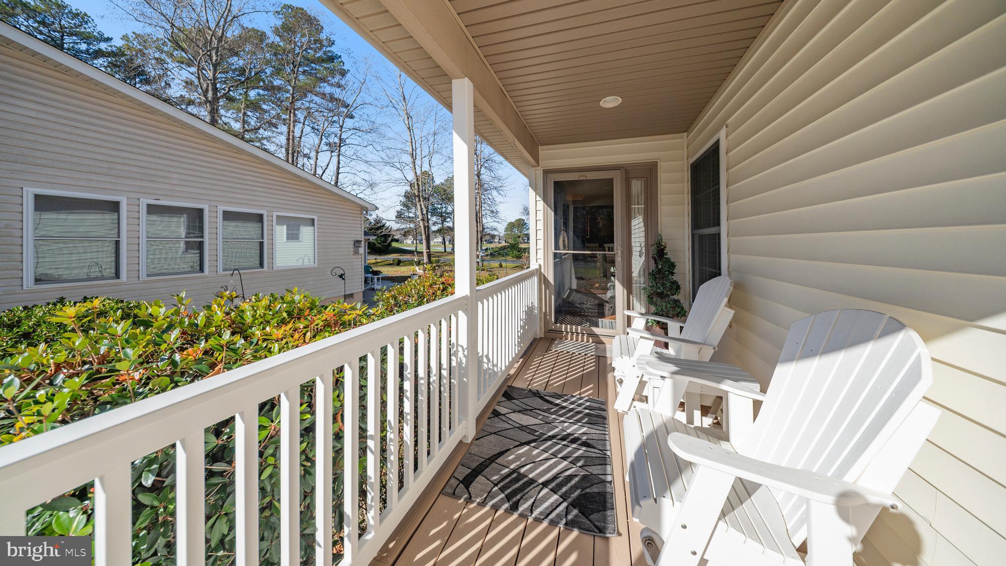 128 Sandyhook Road Ocean Pines, MD 21811 - Photo 3 of 37 a view of balcony with wooden floor and bench in back