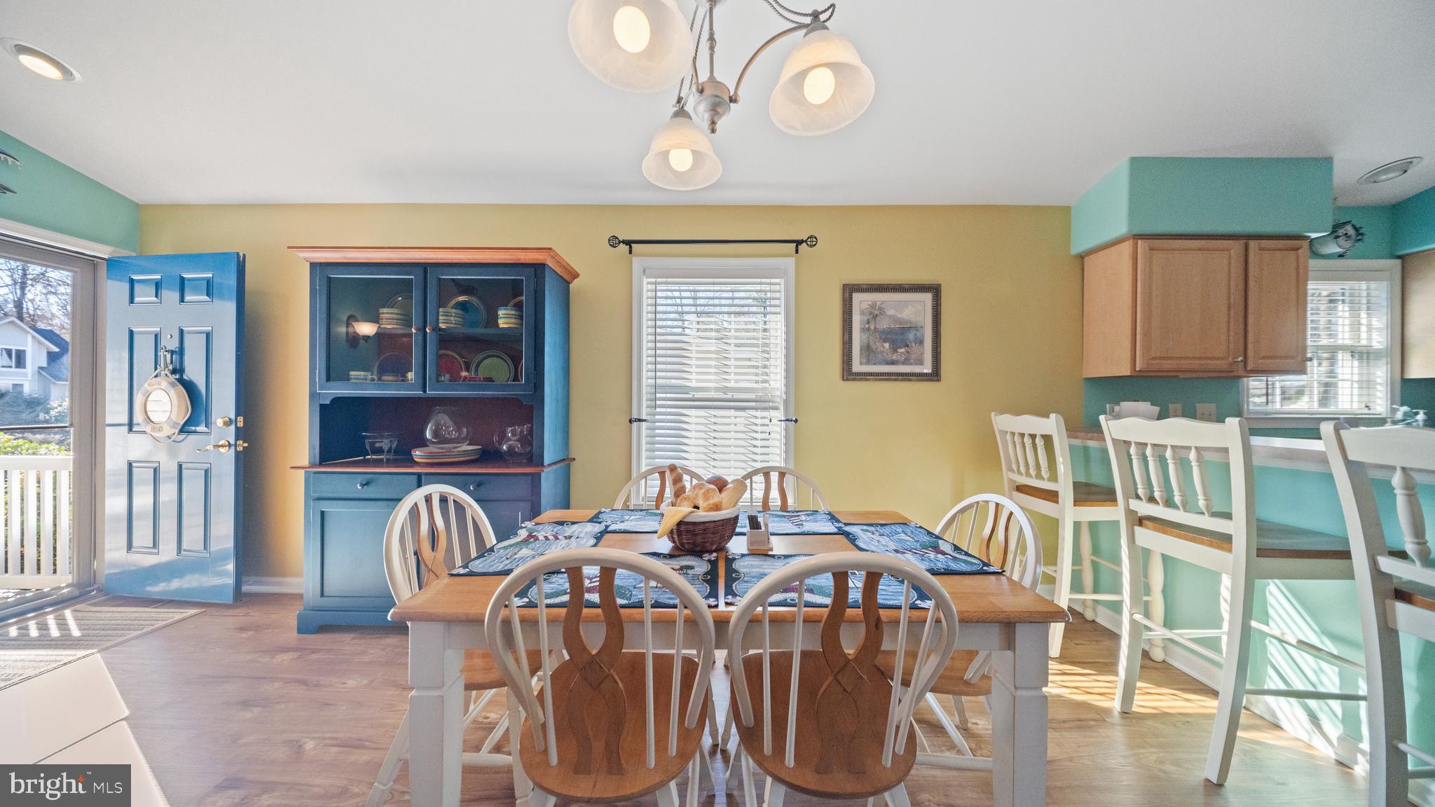128 Sandyhook Road Ocean Pines, MD 21811 - Photo 6 of 37 a view of a dining room with furniture a chandelier and wooden floor