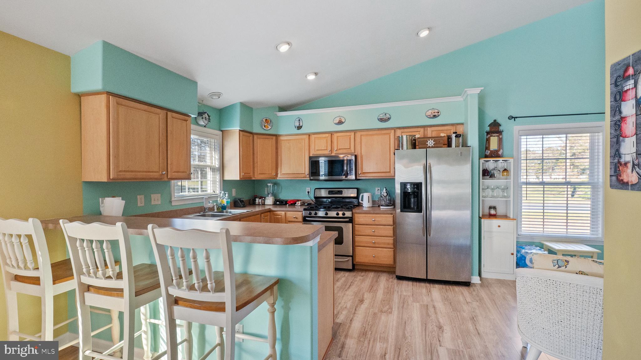 128 Sandyhook Road Ocean Pines, MD 21811 - Photo 7 of 37 a kitchen with stainless steel appliances granite countertop a refrigerator and a stove top oven