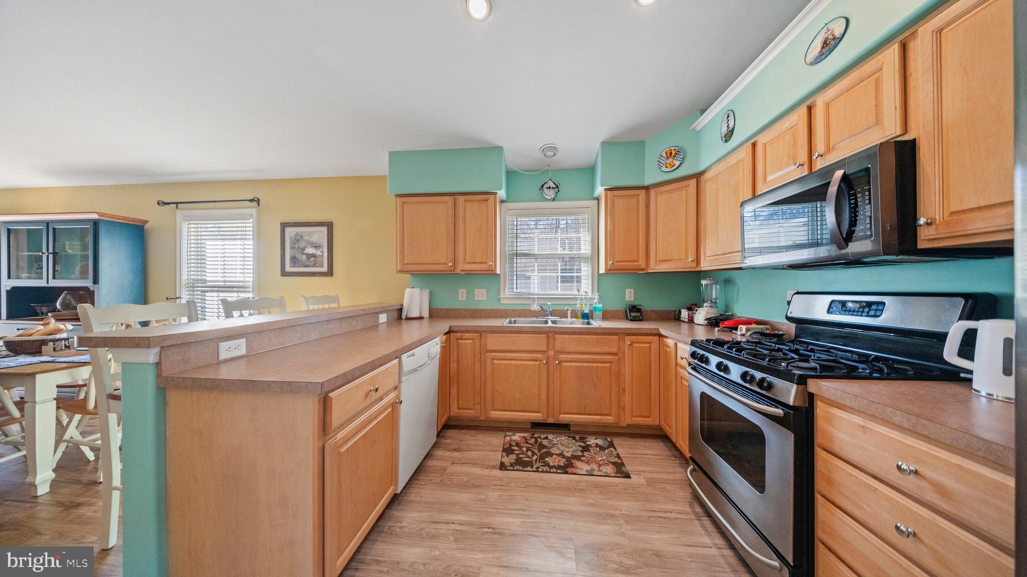 128 Sandyhook Road Ocean Pines, MD 21811 - Photo 8 of 37 a kitchen with stainless steel appliances granite countertop a stove a sink and a microwave