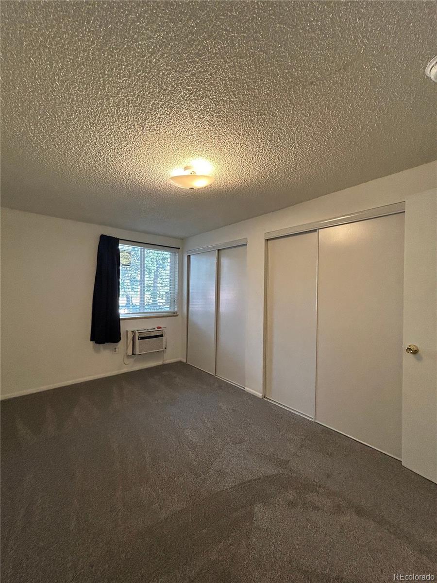 1306 South Parker Road, Unit 167 Denver, CO 80231 - Photo 10 of 14 an empty room with windows and closet