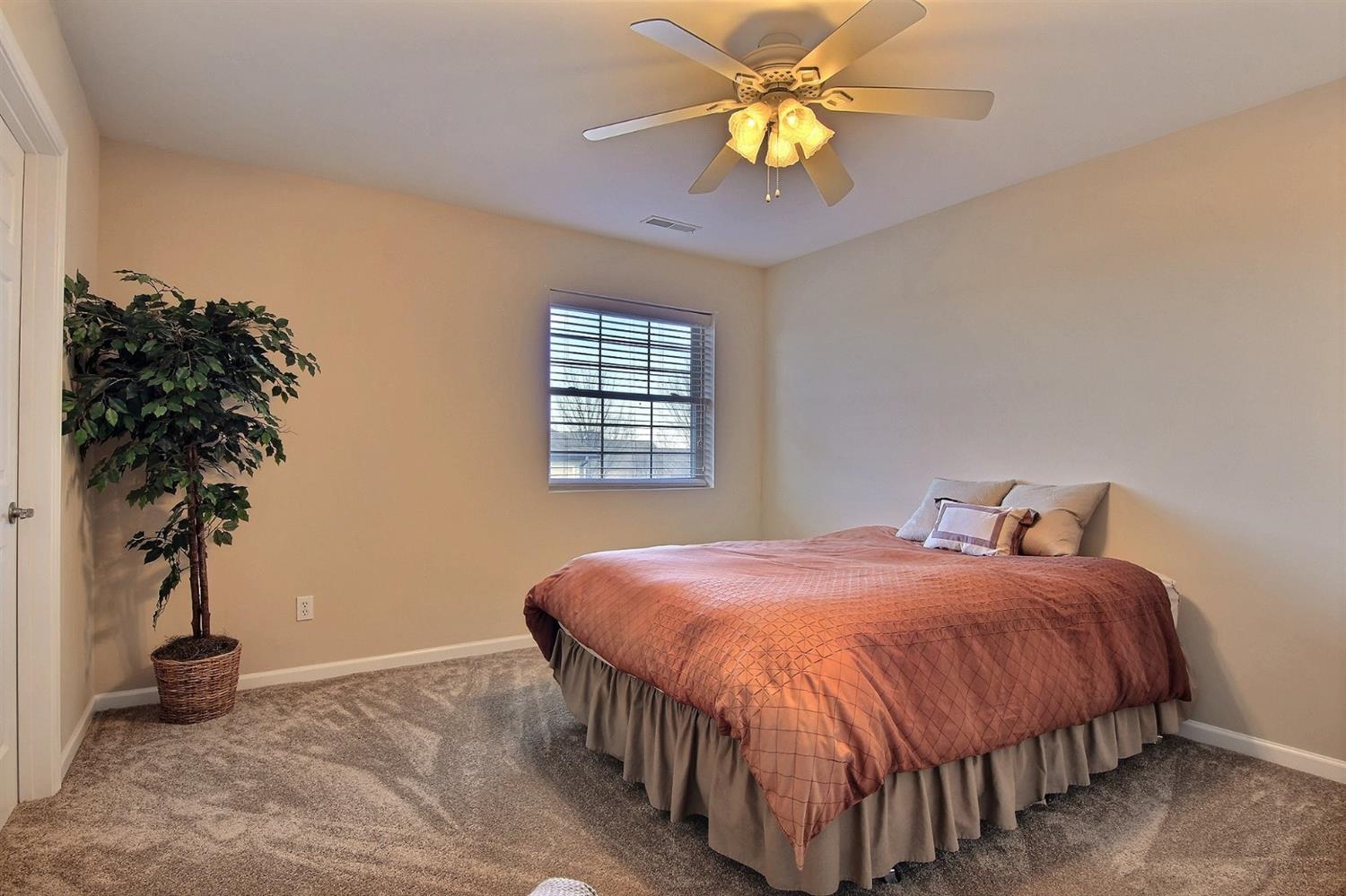 10511 Pike Street Crown Point, IN 46307 - Photo 17 of 26 a bedroom with a bed and a potted plant