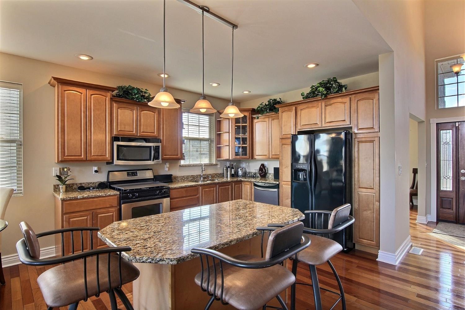 10511 Pike Street Crown Point, IN 46307 - Photo 9 of 26 a kitchen with stainless steel appliances wooden floor dining table and chairs