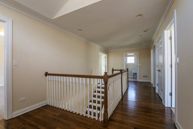 1059 Shermer Road Northbrook, IL 60062 - Photo 14 of 23 a view of a hallway with wooden floor and staircase
