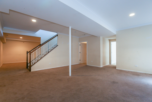 1059 Shermer Road Northbrook, IL 60062 - Photo 17 of 23 a view of an empty room with stairs and a window