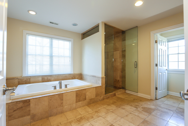 1059 Shermer Road Northbrook, IL 60062 - Photo 20 of 23 a spacious bathroom with a tub and shower