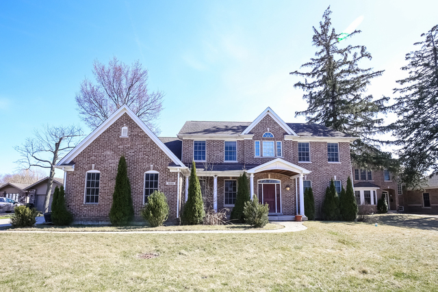 1059 Shermer Road Northbrook, IL 60062 - Photo 3 of 23 a front view of a house with a yard
