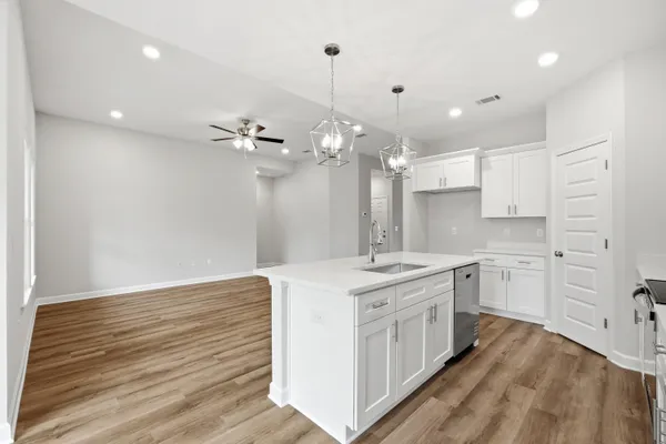 a kitchen with a white island cabinets and appliances