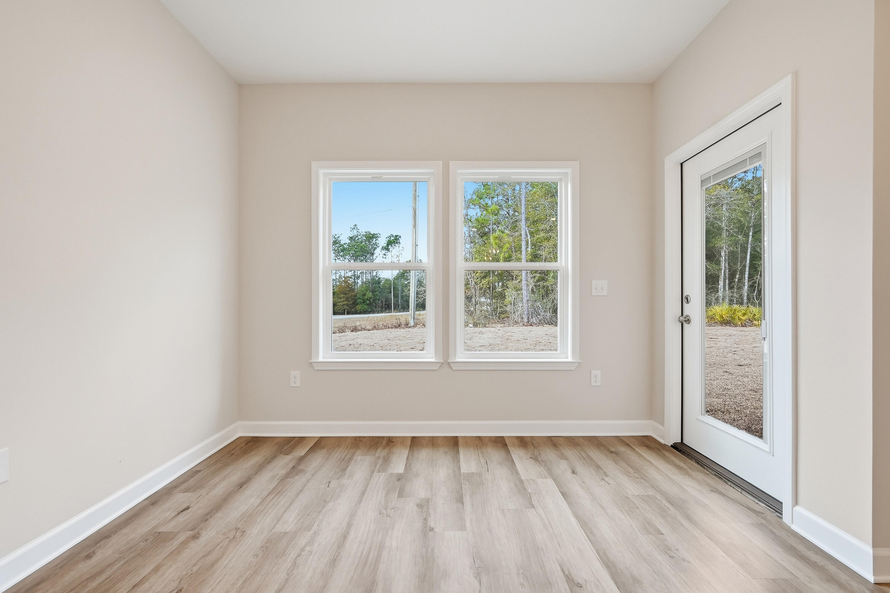 6102 Mildreds Way Crestview, FL 32539 - Photo 14 of 25 an empty room with wooden floor and windows