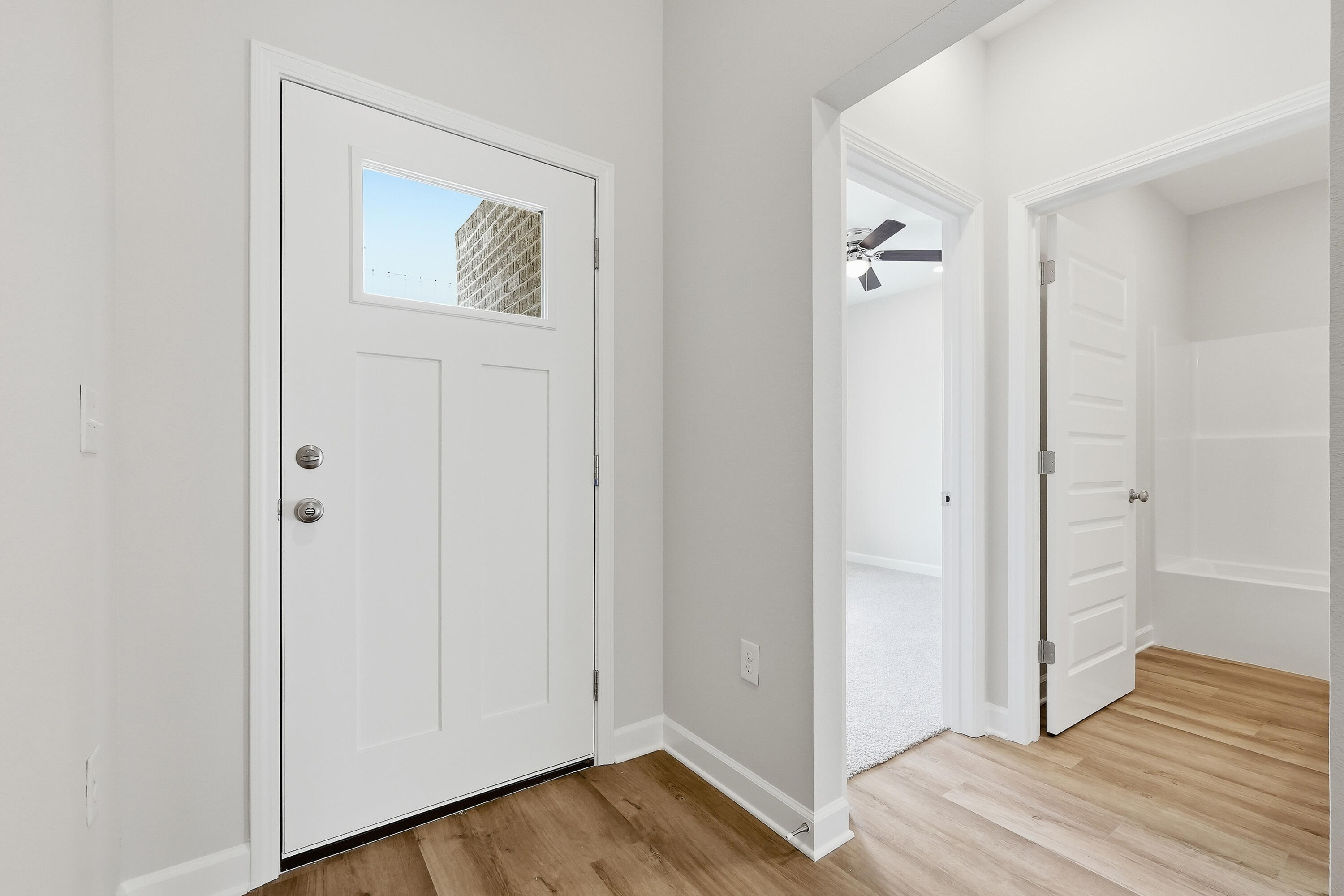 6102 Mildreds Way Crestview, FL 32539 - Photo 3 of 25 a view of a hallway with wooden floor