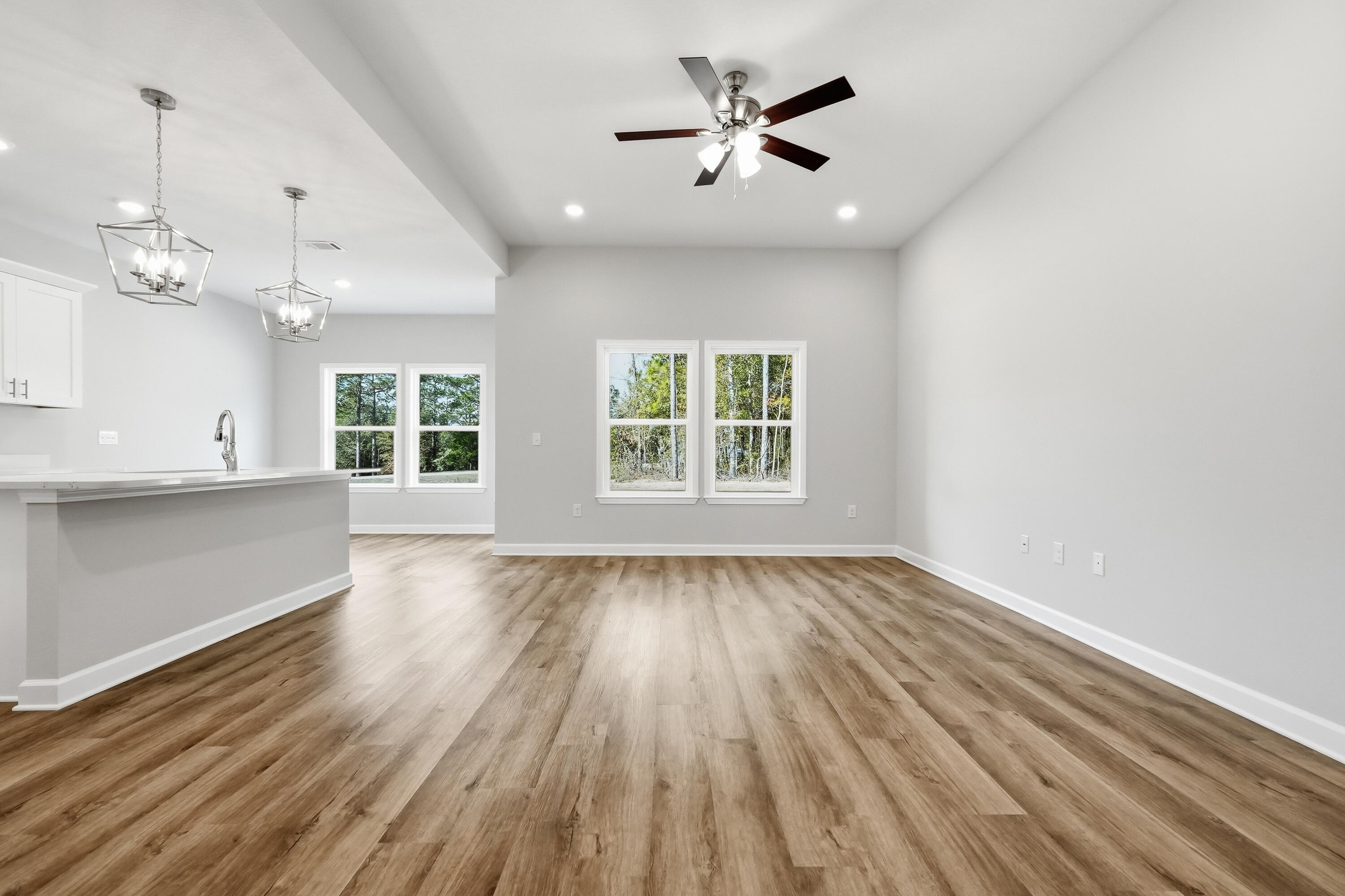 6102 Mildreds Way Crestview, FL 32539 - Photo 4 of 25 a view of an empty room with a window and wooden floor
