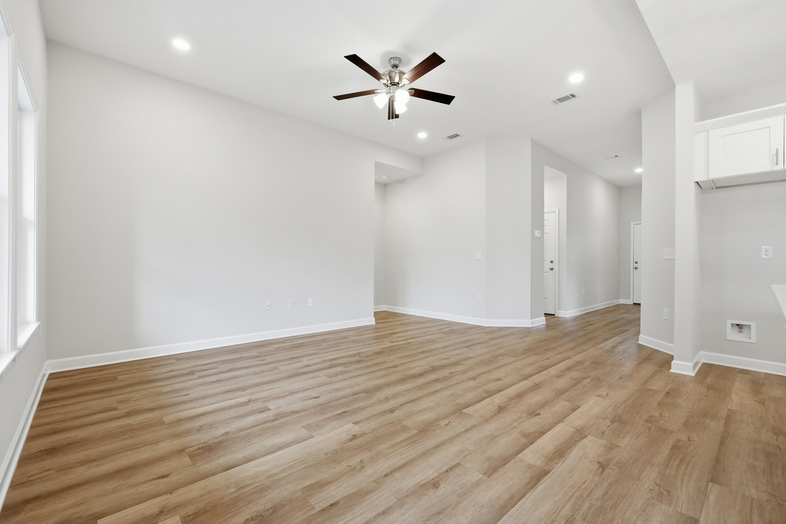 6102 Mildreds Way Crestview, FL 32539 - Photo 8 of 25 an empty room with wooden floor and ceiling fan